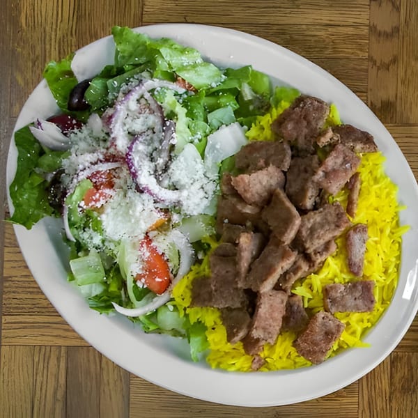 Shish Kebab House of Tucson's gyro plate with meat, yellow rice, and a fresh salad.