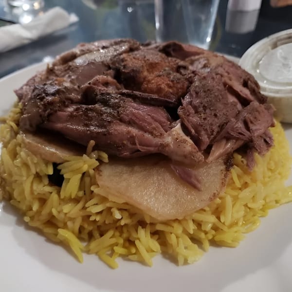 Shish Kebab House of Tucson's Mediterranean dish with yellow rice, meat, and potatoes.